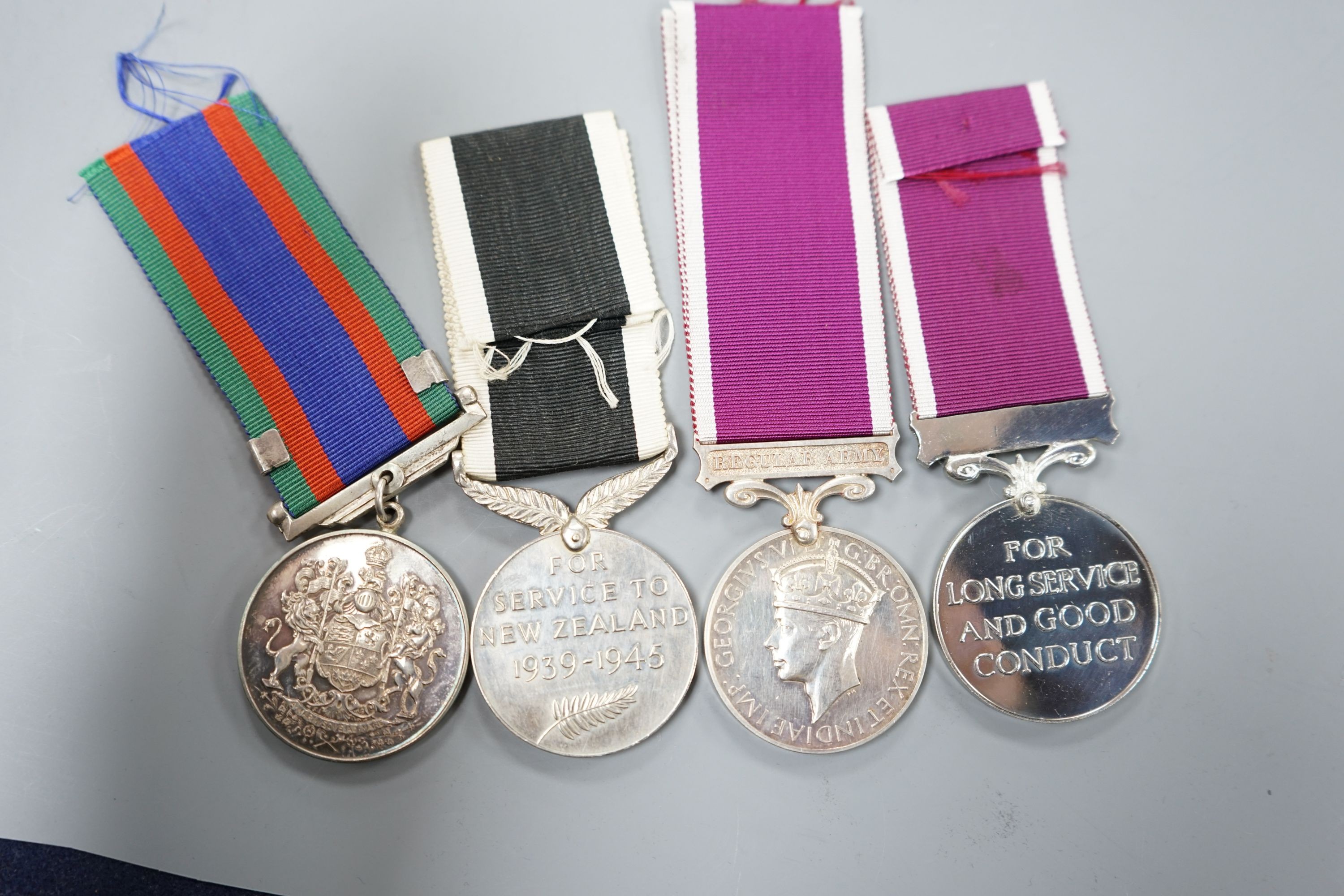 Four WW2 and QEII Commonwealth medals - New Zealand War Service and For Long Service and Good Conduct medals, Canada Voluntary Service medal and a Regular Army For Long Service and Good Conduct medal